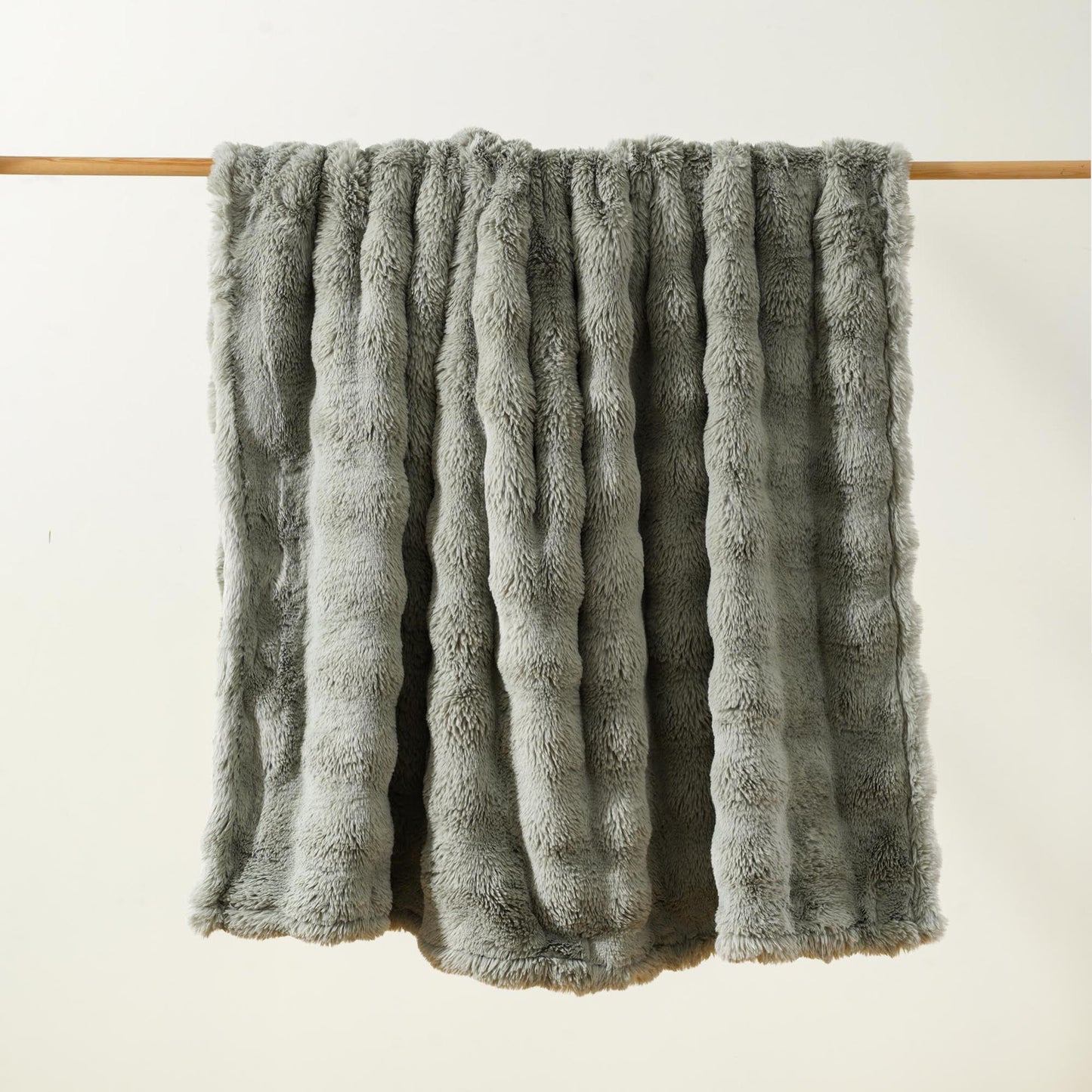 Brook Snuggle minky blanket Sage colorway hanging lightly bubbled ultra soft texture medium weight Wrapped in Love Pocket Love Movement