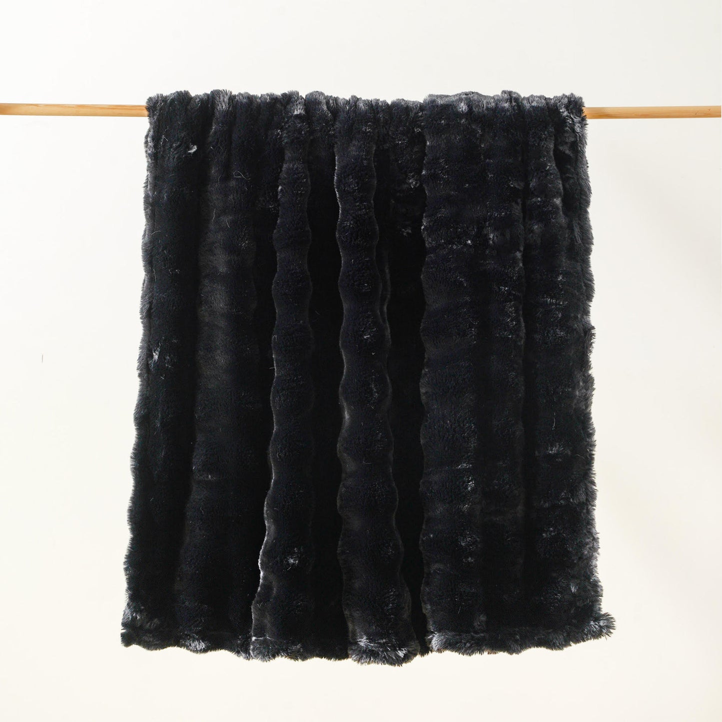 Brook Snuggle minky blanket black colorway hanging lightly bubbled ultra soft texture medium weight Wrapped in Love Pocket Love Movement